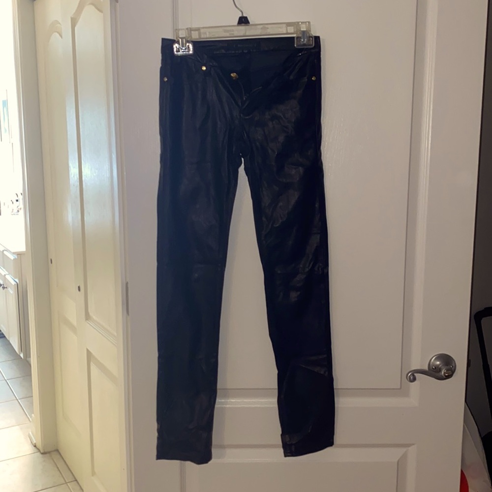 black leather pants , gold buttons